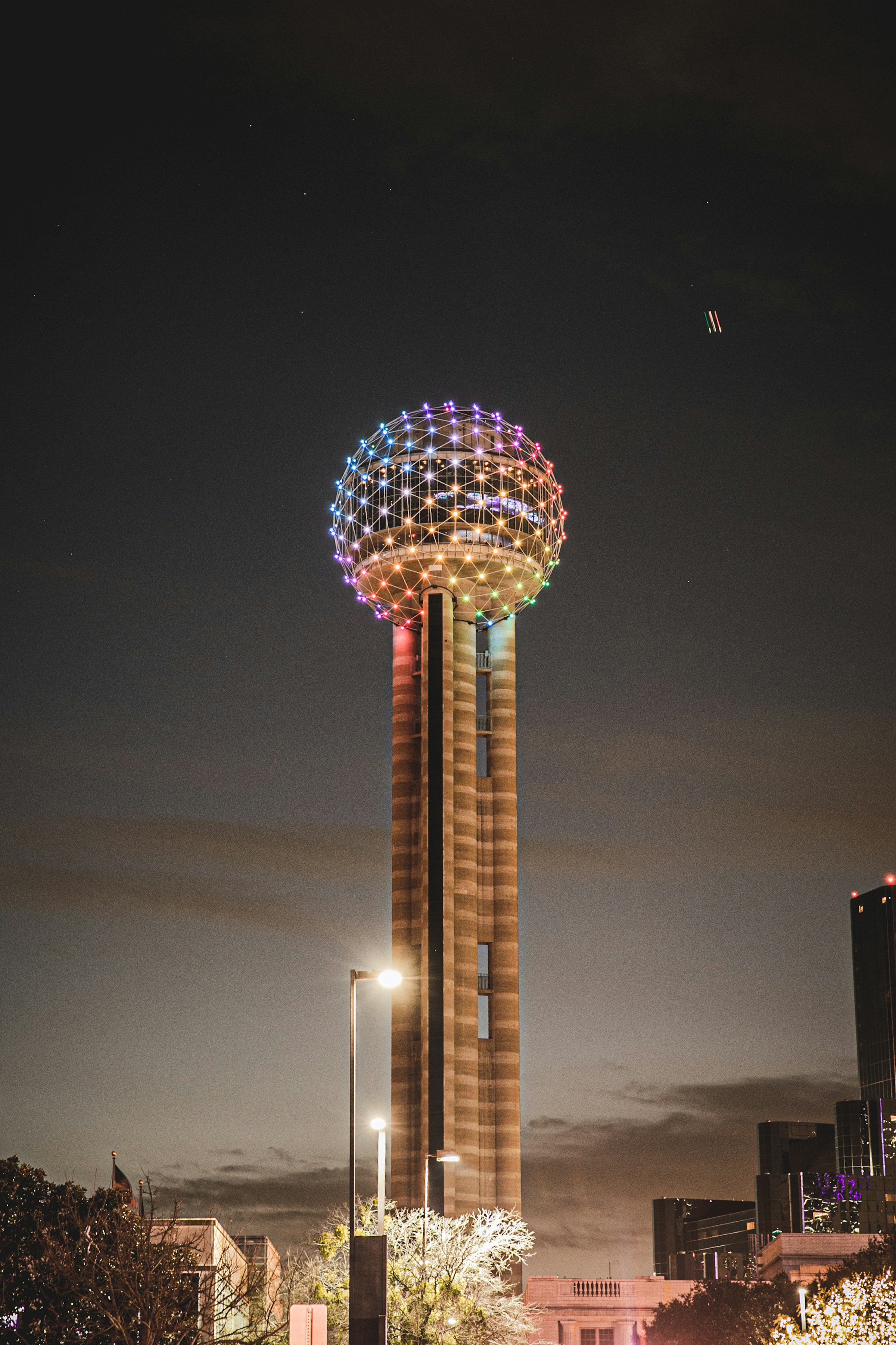 Reunion Tower illuminated over Downtown Dallas at night
